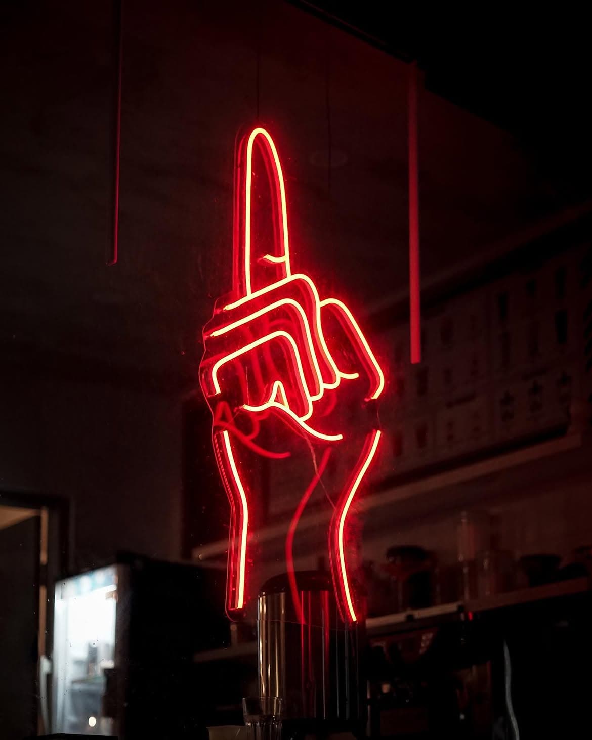 Neon merah berbentuk ikon telunjuk Kopi Satu Bang di dalam kedai